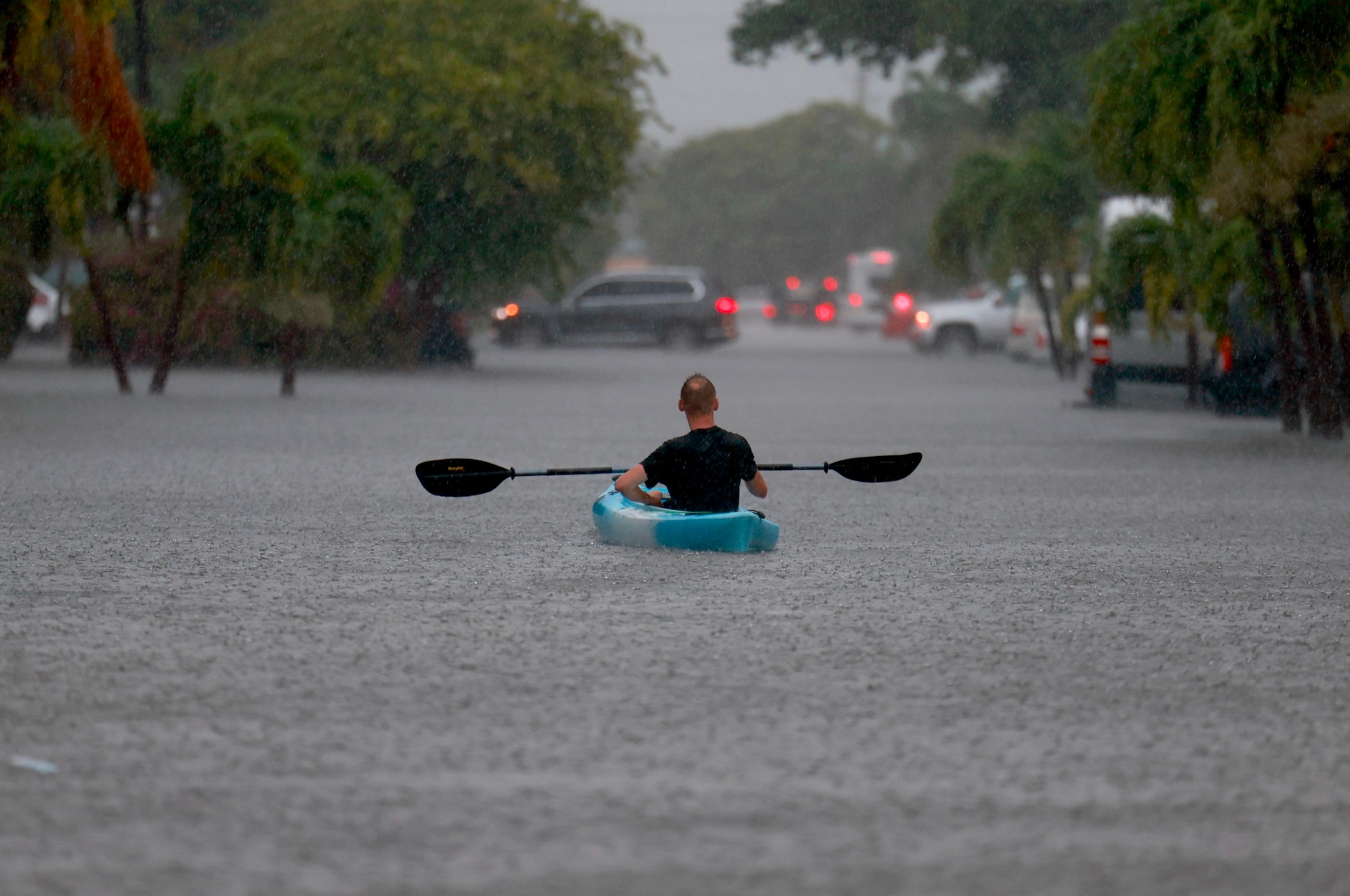 PHOTO: A person uses a kayak to float through a flooded street on June 12, 2024, in Hollywood, Florida. As tropical moisture passes through the area, areas have become flooded due to the heavy rain.