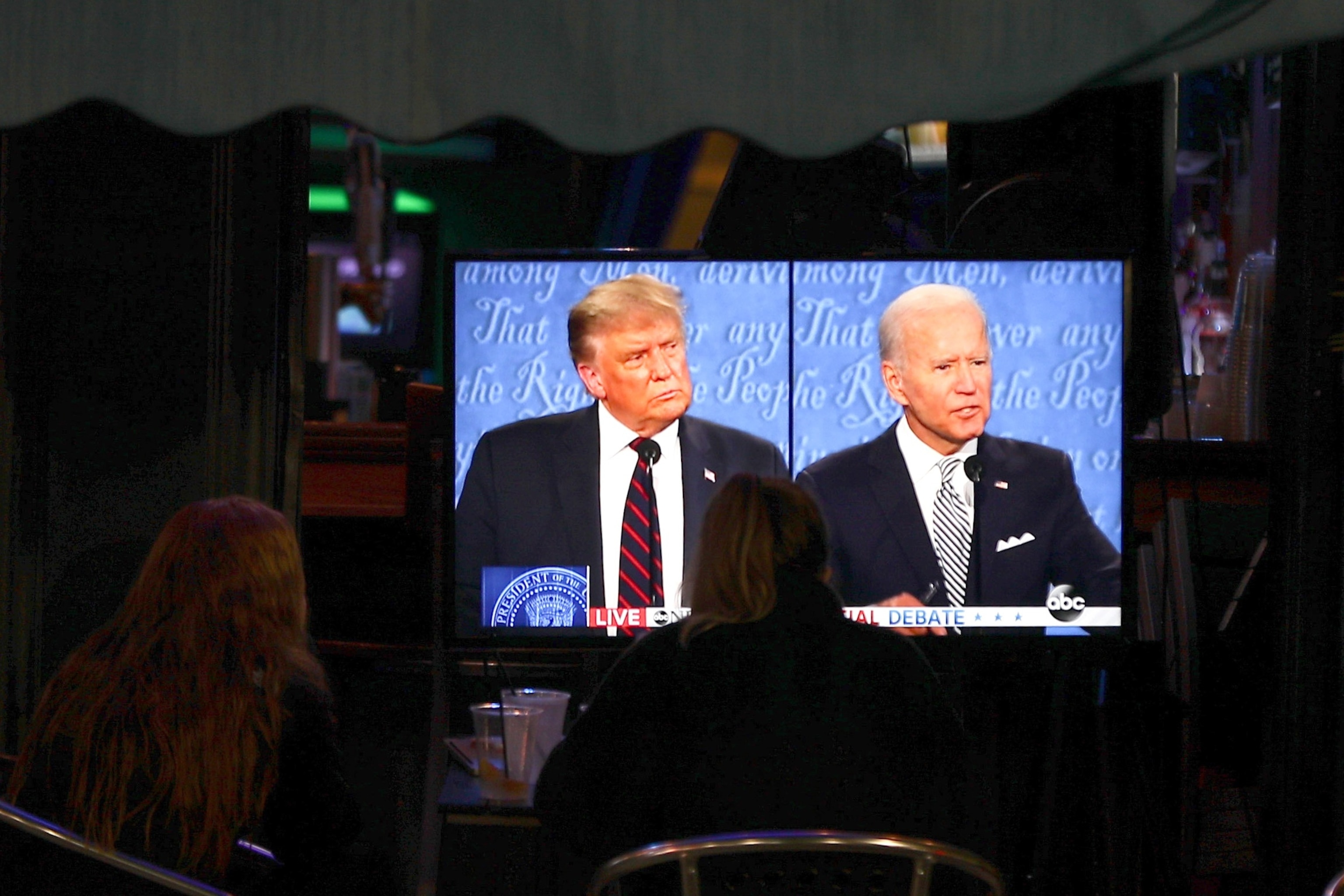 PHOTO: In this Sept. 29, 2020 file photo people watch the first presidential debate between President Donald J. Trump and Former Vice President Joe Biden, on in Hoboken, N.J.