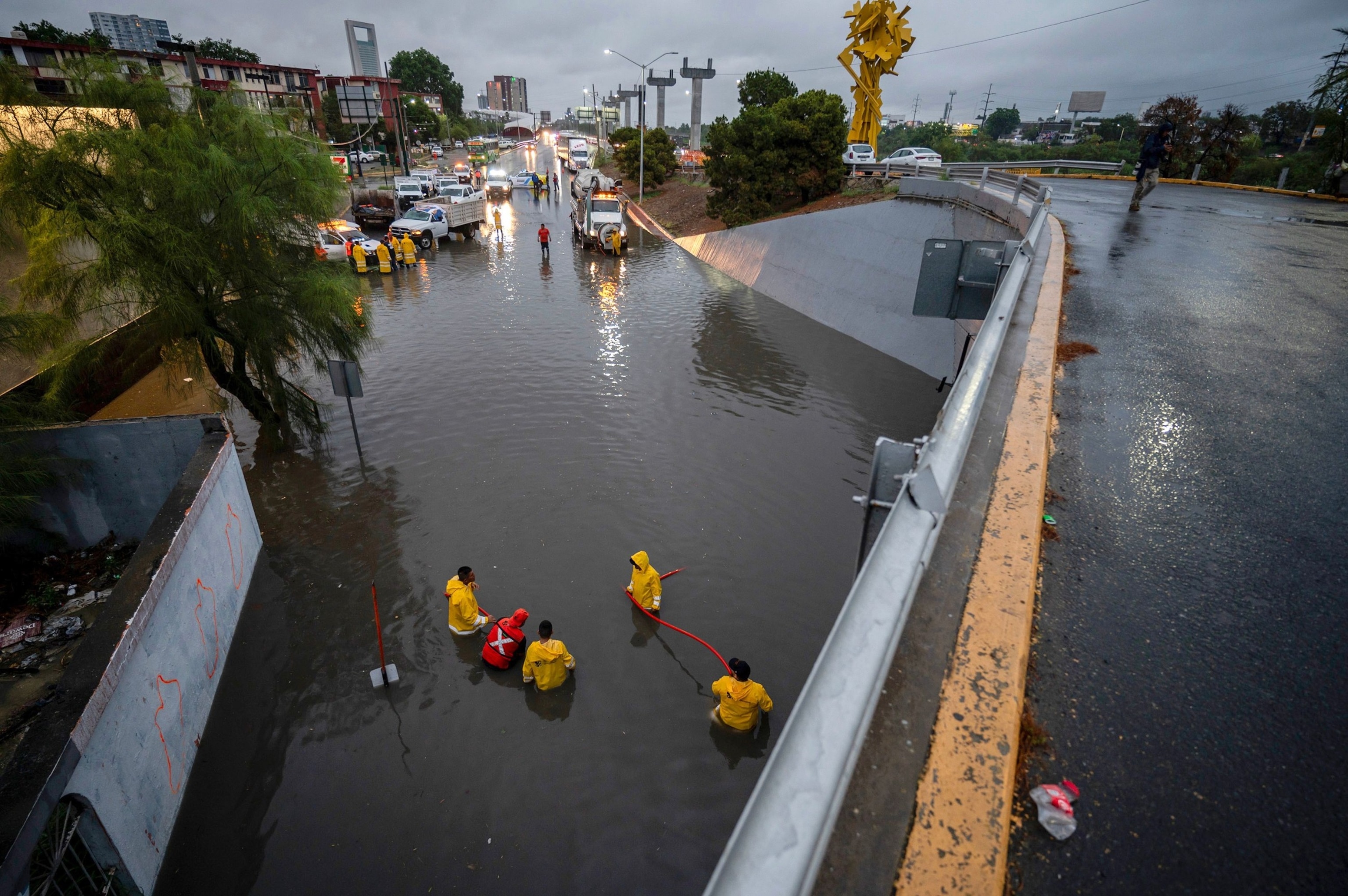 PHOTO: Members of Civil Protection work on a slope flooded by heavy rains in Monterrey, Mexico, June 19, 2024.