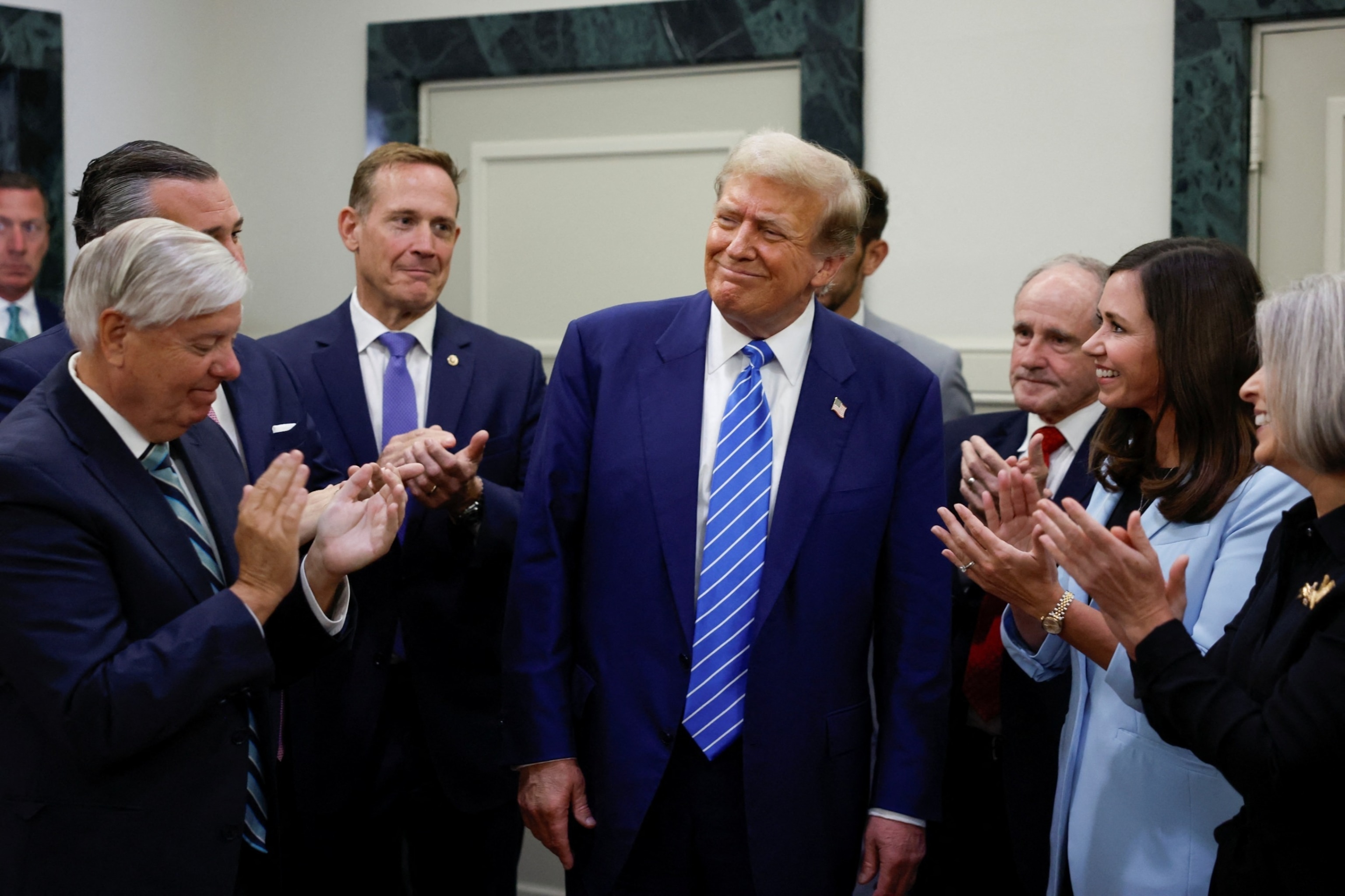 PHOTO: Former President Donald Trump reacts as he is applauded by Republicans at the National Republican Senatorial Committee (NRSC) headquarters in Washington, June 13, 2024. 