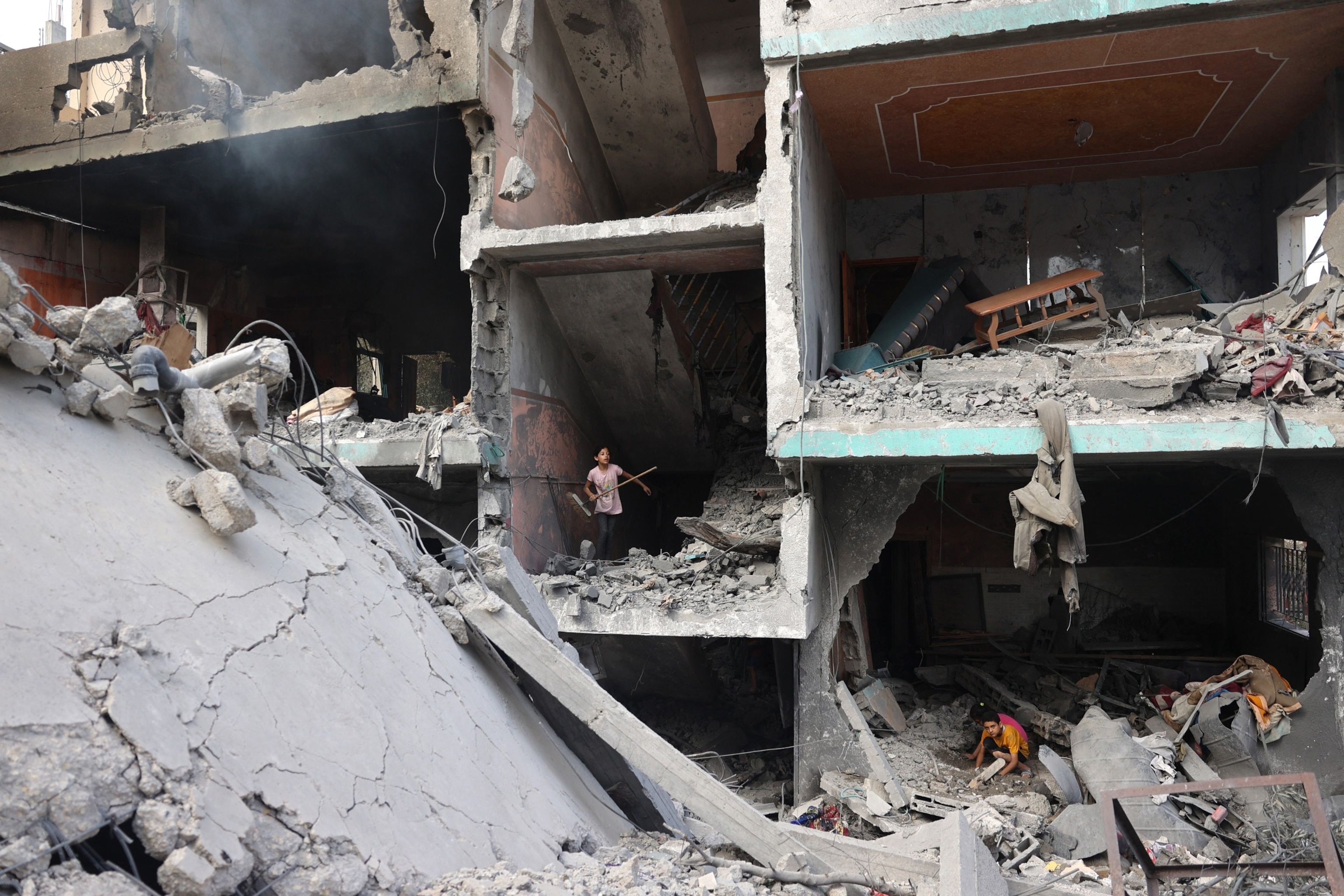 PHOTO: Palestinians children search through the rubble of their home a day after an operation by the Israeli Special Forces in the Nuseirat camp, in the central Gaza Strip on June 9, 2024.