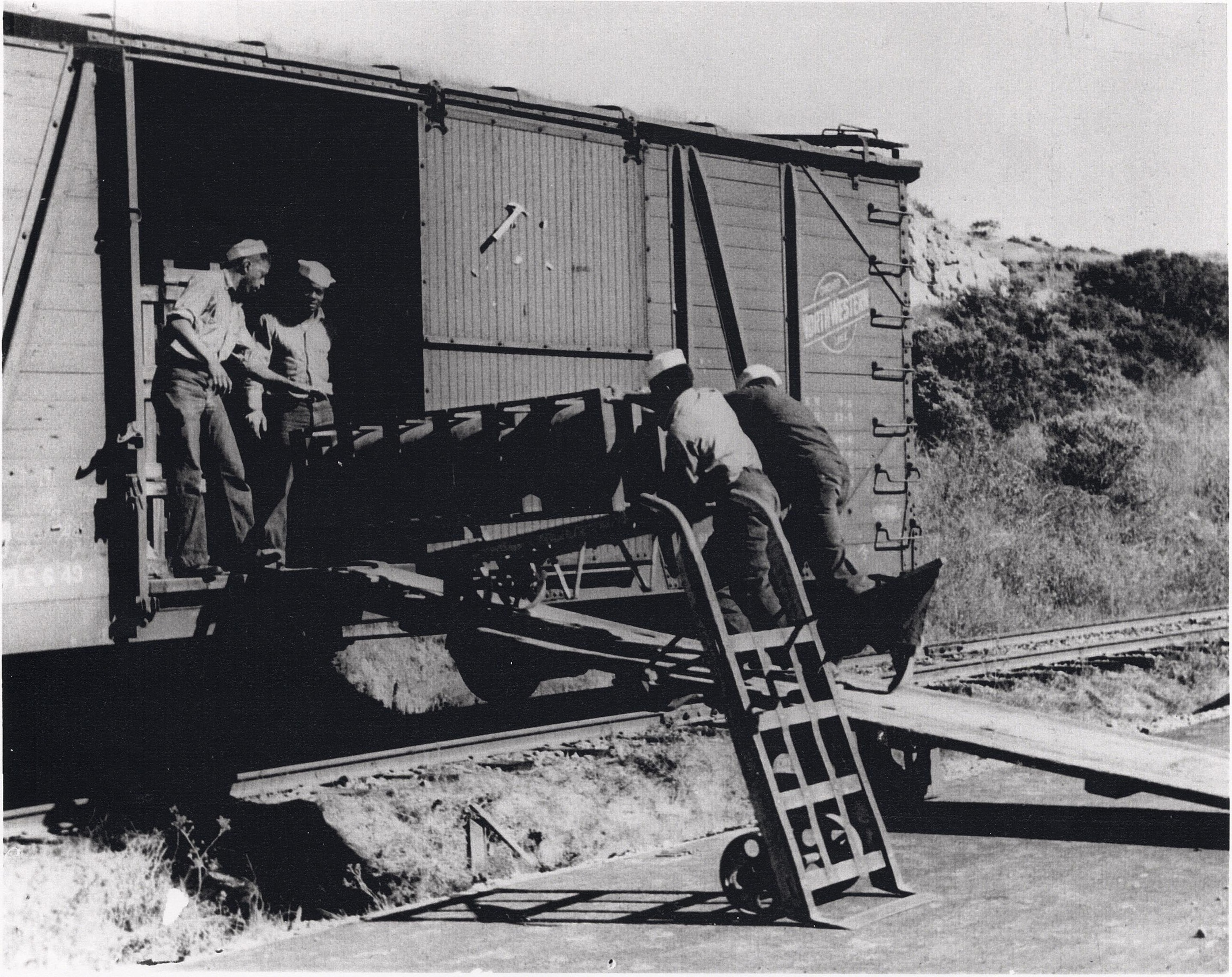 PHOTO: African American Sailors of a naval ordnance battalion are seen unloading aerial bombs from a railcar, Port Chicago Naval Magazine, circa 1943/44. 