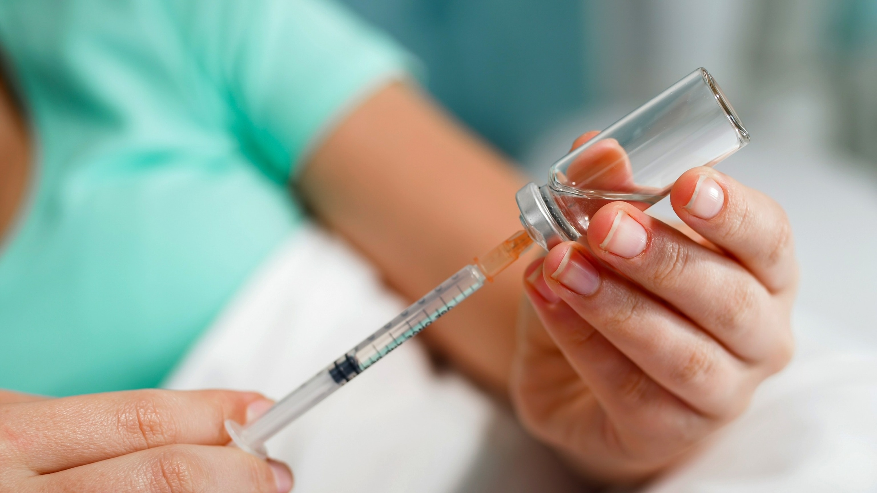 PHOTO: Stock photo of a person filling a syringe.