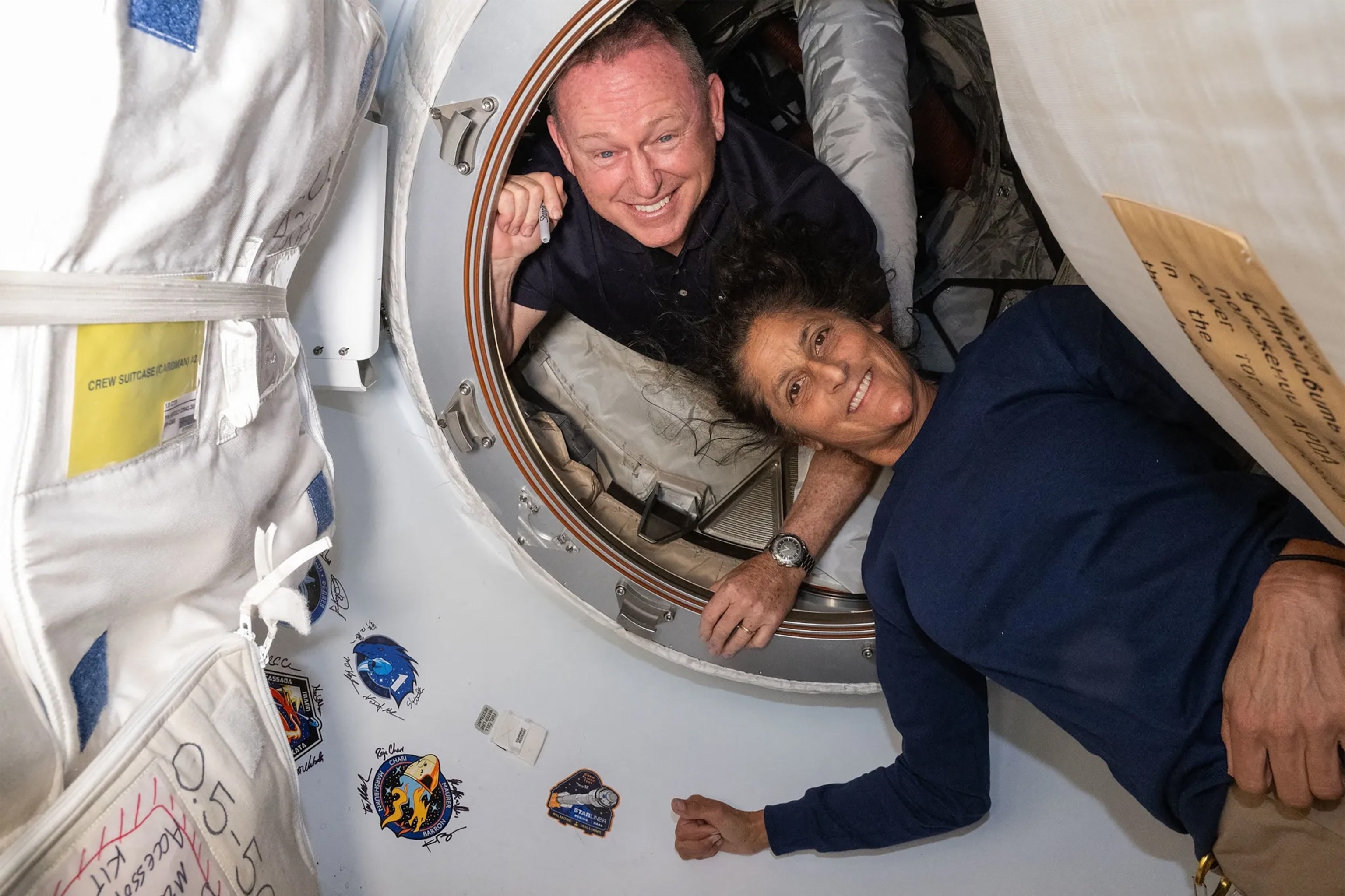 PHOTO: This NASA picture released on July 2, 2024 shows NASA's Boeing Crew Flight Test astronauts Wilmore and Williams inside the vestibule between the forward port on the International Space Station's Harmony module and Boeing's Starliner spacecraft. 