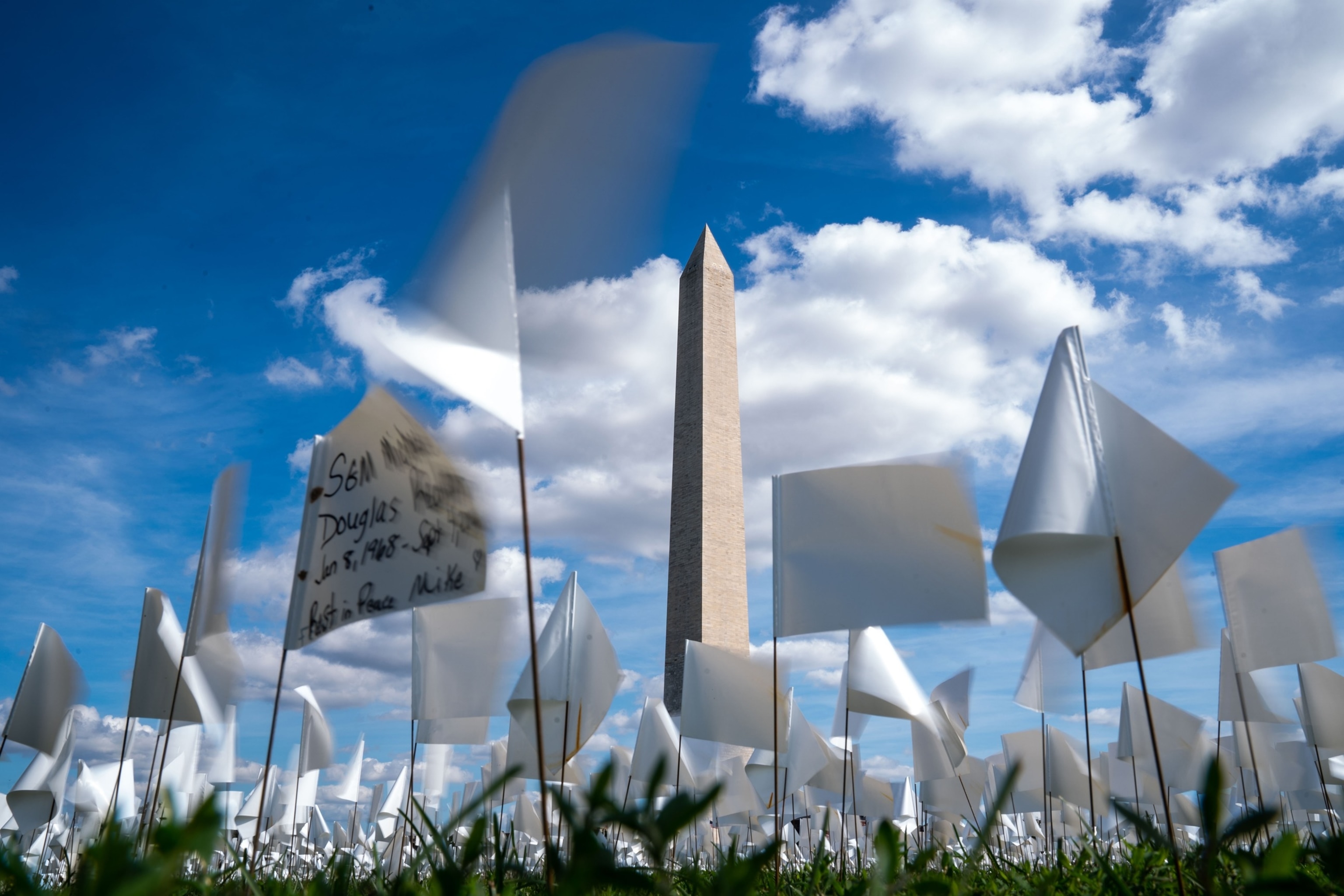 PHOTO: People visit the 'In America: Remember' public art installation near the Washington Monument on the National Mall on Monday, Sept. 20, 2021 in Washington, DC.