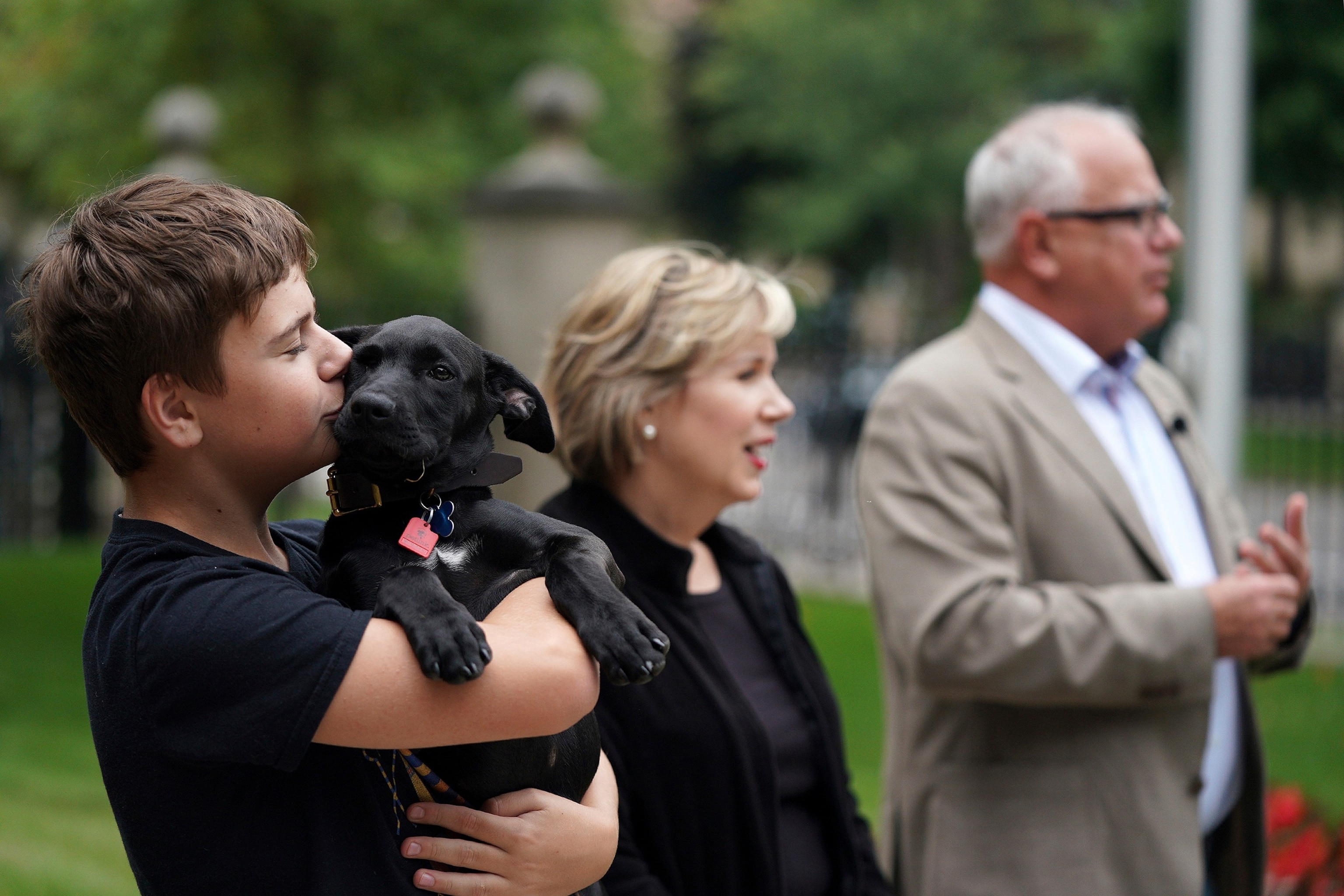 PHOTO: In this Sept. 5, 2019, file photo, Gus Walz, left, holds Scout, a 3-month-old Labrador Retriever the Walz family adopted, during a news conference to announce the family's newest addition at the governor's residence.