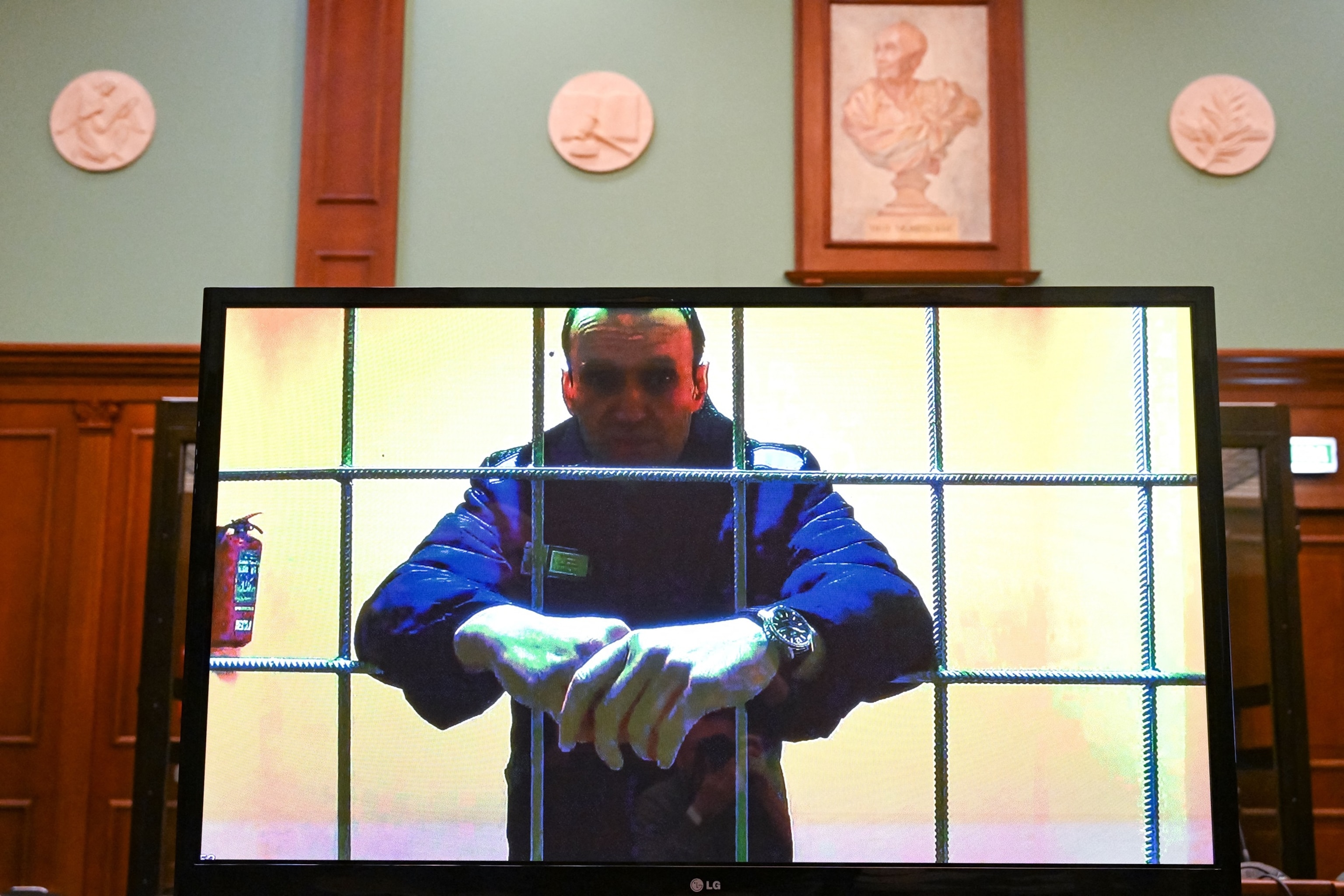 PHOTO: Opposition leader Alexei Navalny appears on a screen set up at a courtroom of the Moscow City Court via a video link from his prison colony, May 17, 2022.