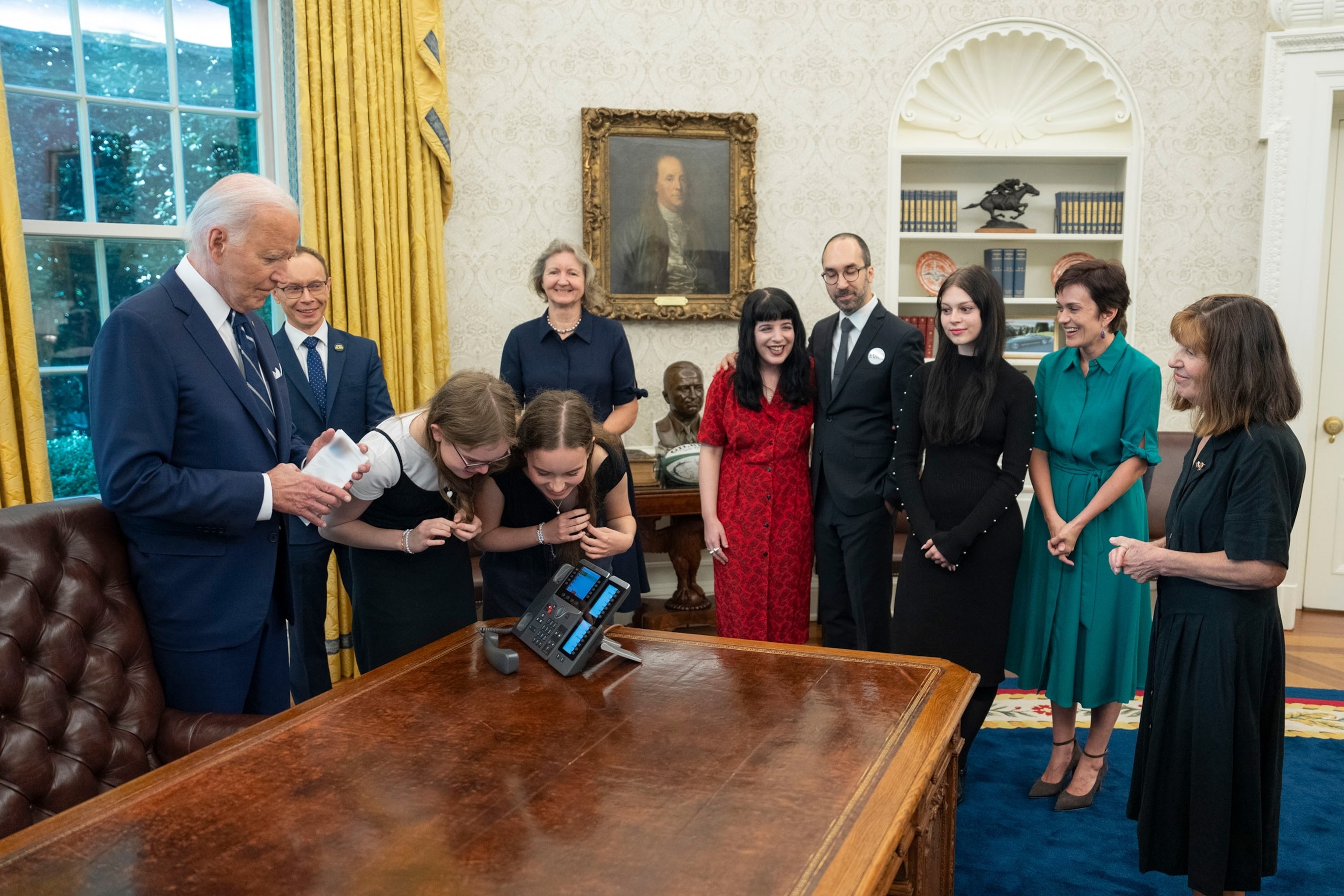 PHOTO: President Joe Biden stands beside the families of Paul Whelan, Evan Gershkovich, Alsu Kurmasheva, and Vladimir Kara-Murza in the Oval Office as they speak to their loved ones for the first time since they regained freedom, Aug. 1, 2024.