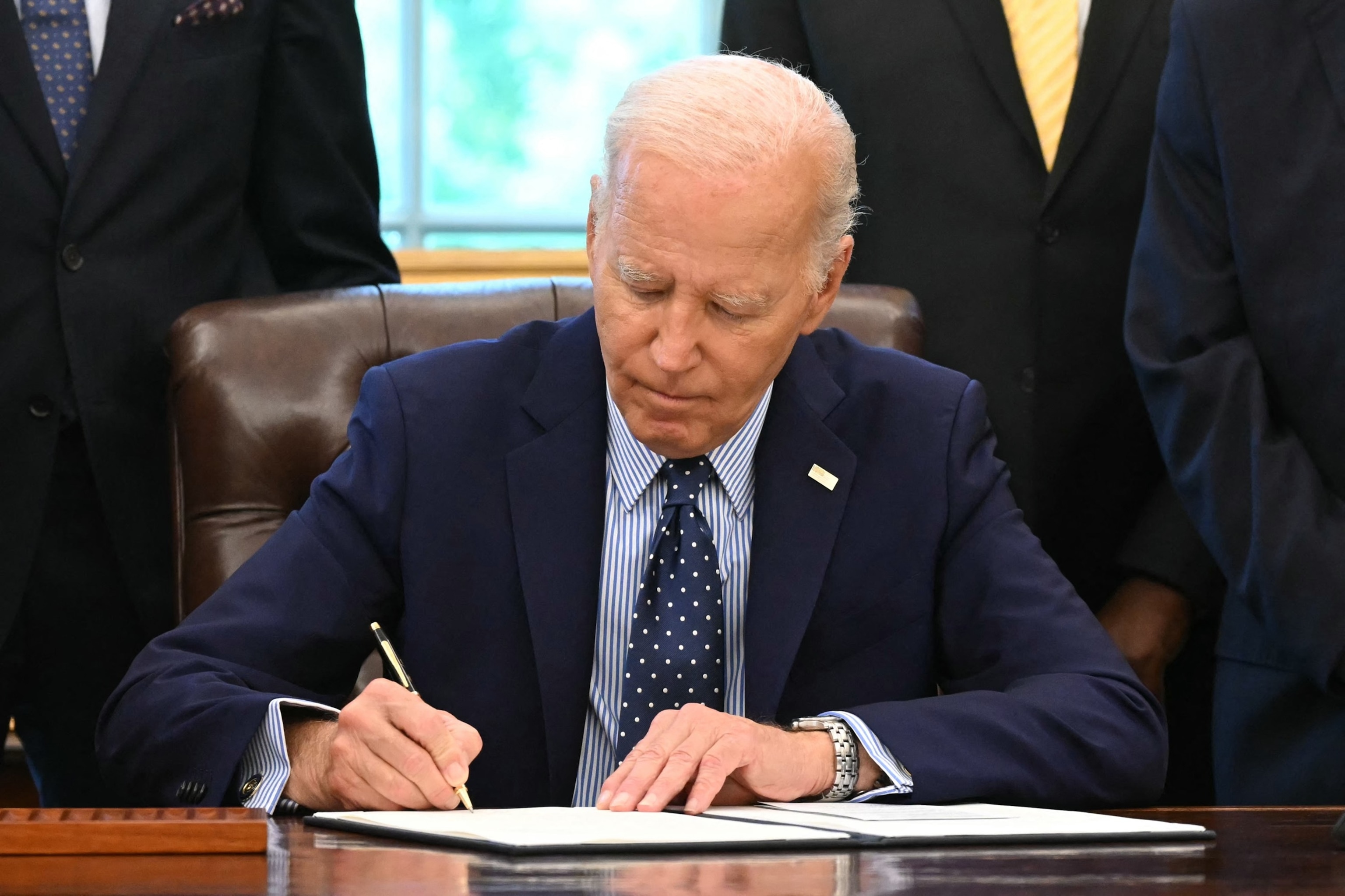 PHOTO: President Joe Biden signs a proclamation to designate the Springfield 1908 Race Riot National Monument, in the Oval Office of the White House in Washington, DC, Aug. 16, 2024. 