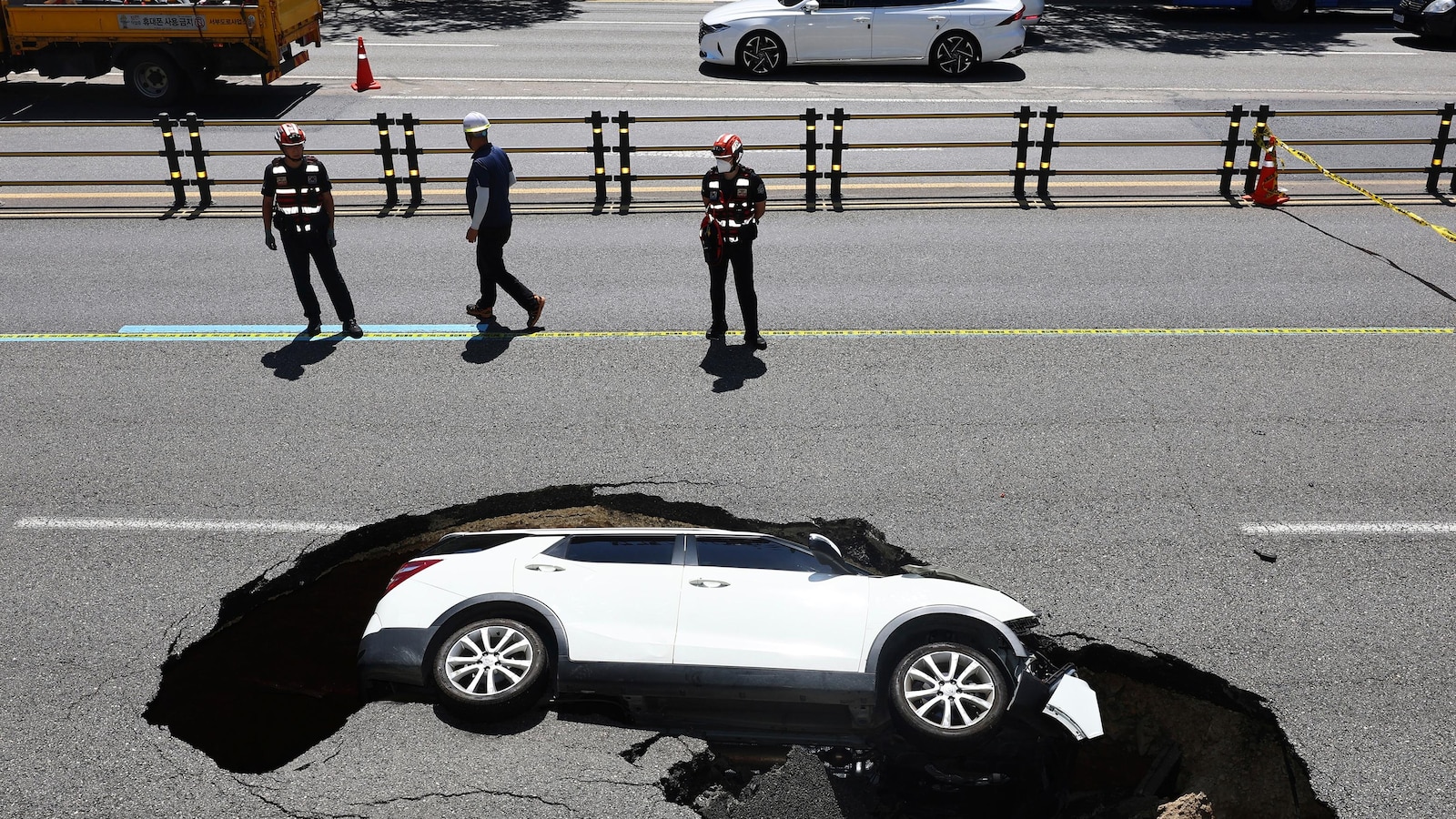 Two individuals injured when an SUV is engulfed by sinkhole