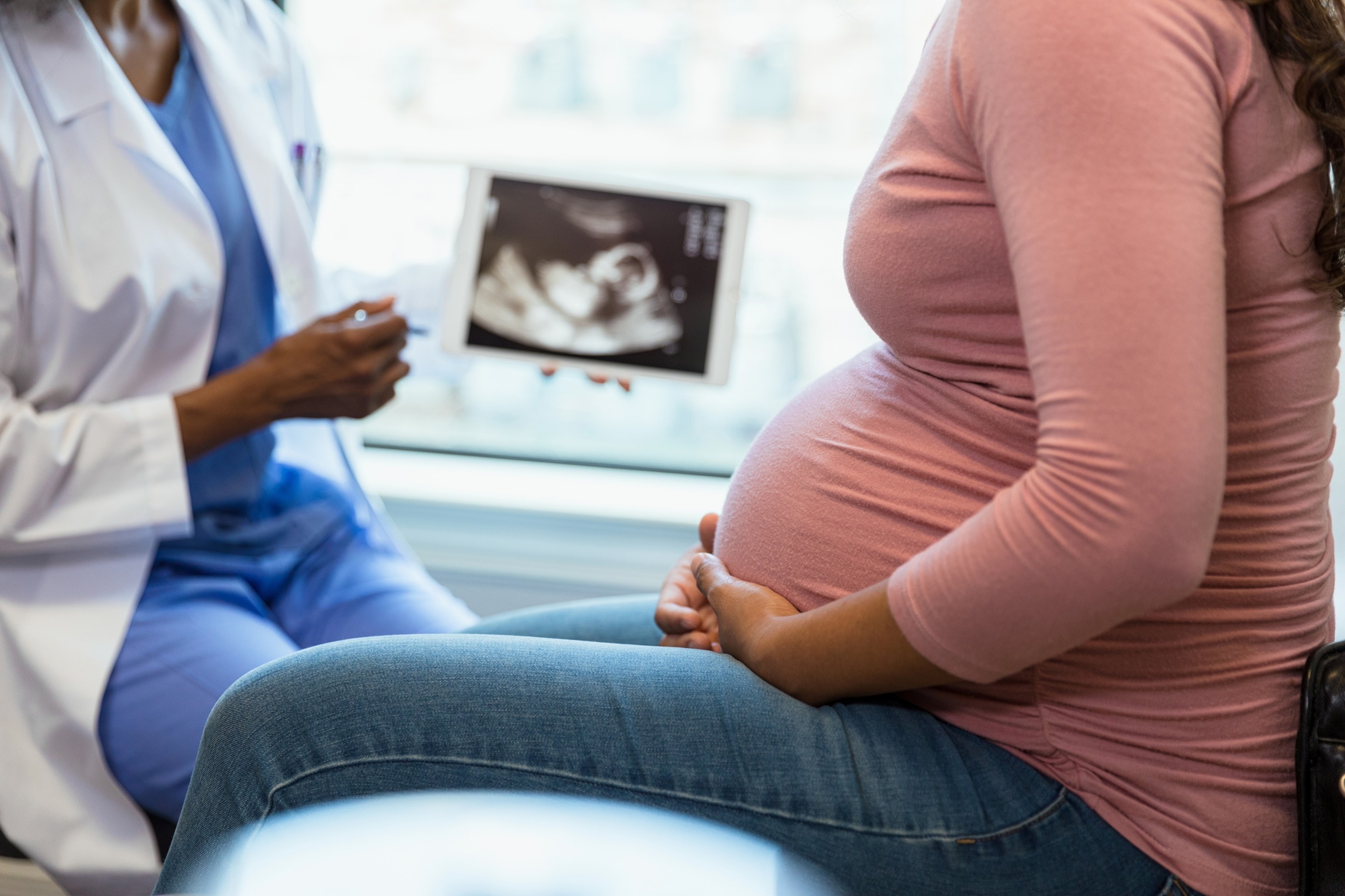 PHOTO: A pregnant woman looks at ultrasound with doctor in an undated stock photo. 