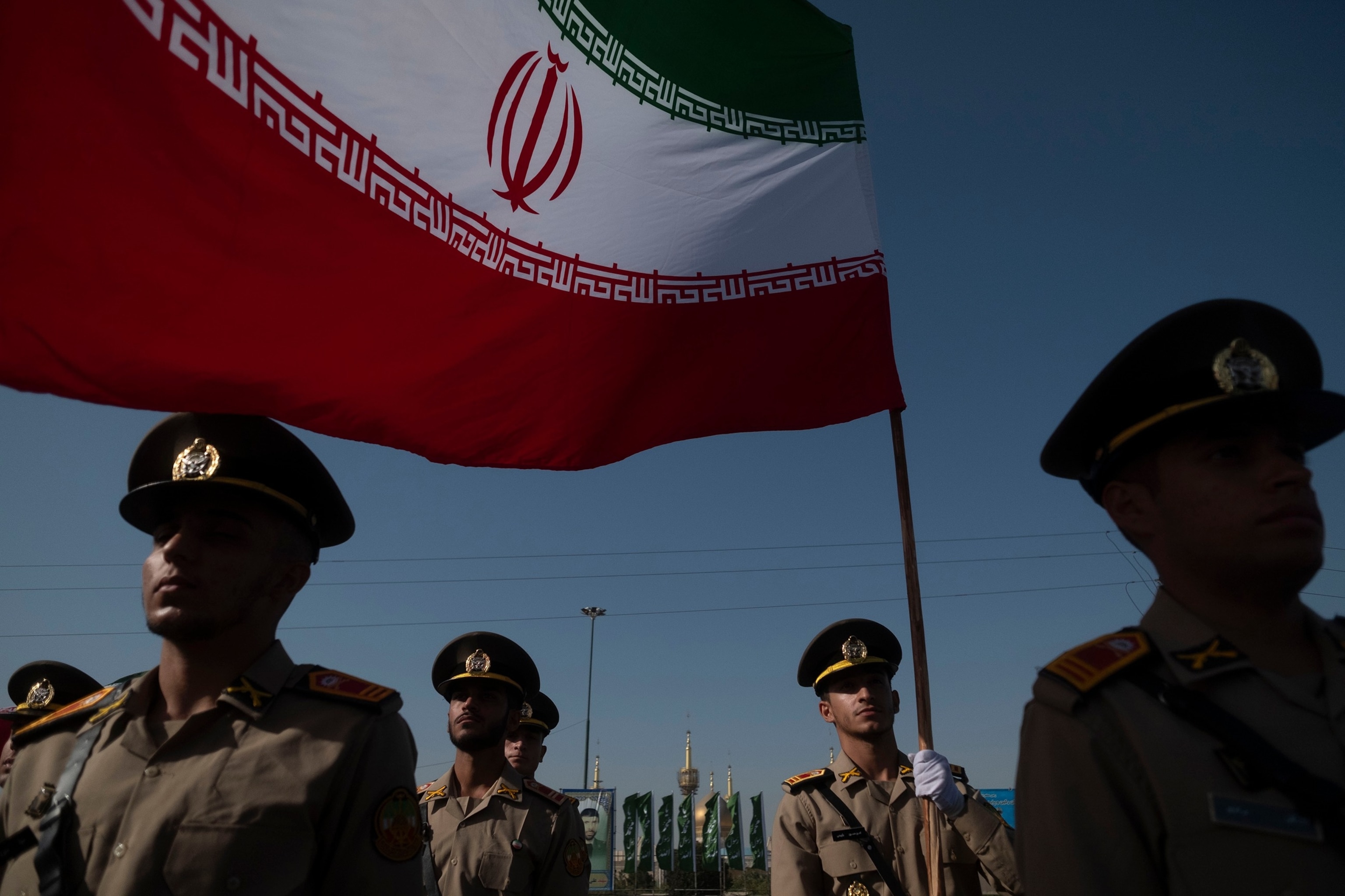 PHOTO: Members of the Iranian Army's land force stand at attention while one of them holds an Iranian flag during a military parade commemorating the anniversary of the Iran-Iraq War (1980-88) in Tehran, Iran, Sept. 21, 2024. 