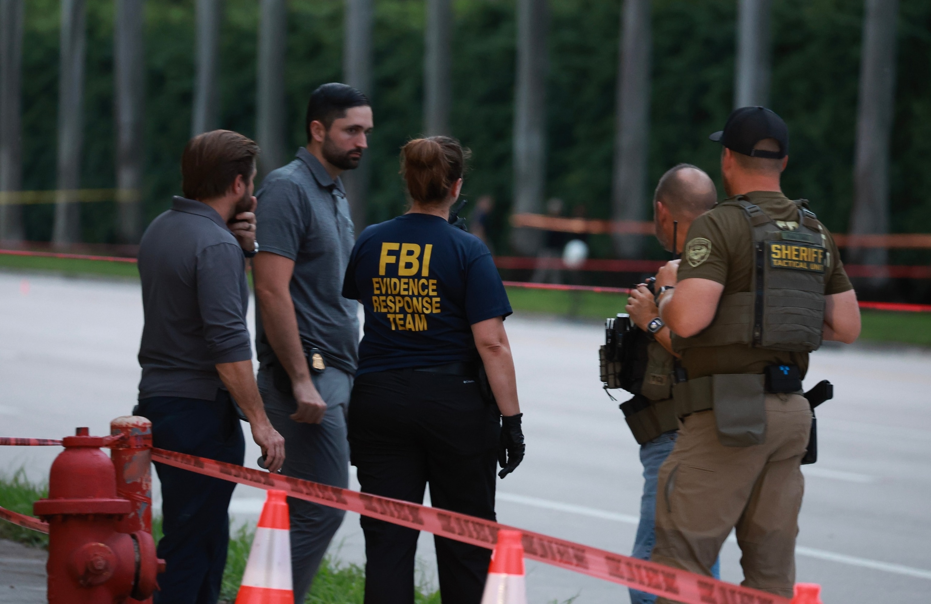 Law enforcement personnel investigate the area around Trump International Golf Club after an apparent assassination attempt of former President Donald Trump on September 15, 2024 in West Palm Beach, Florida. (Photo by Joe Raedle/Getty Images)