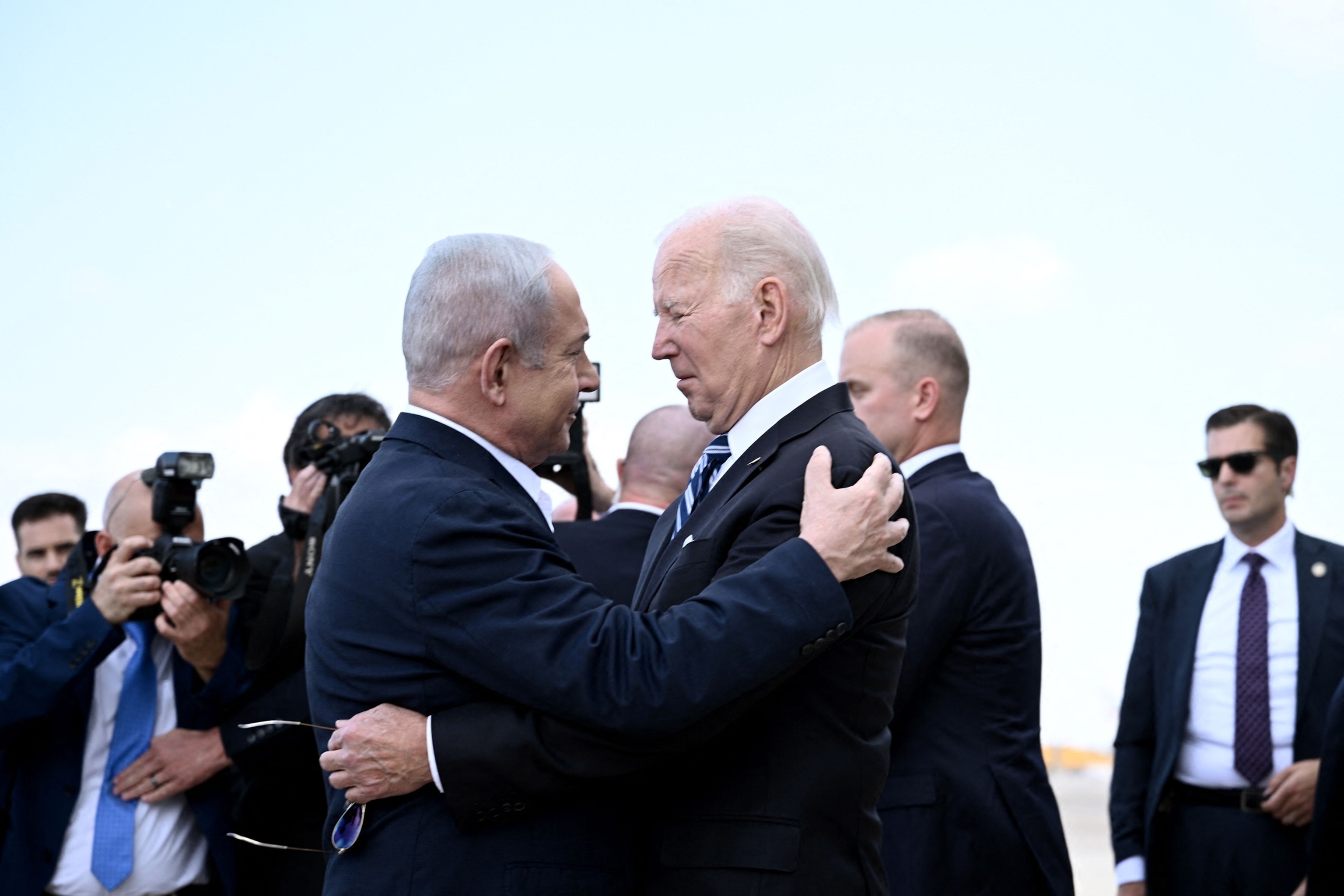 PHOTO: Israel Prime Minister Benjamin Netanyahu (L) greets US President Joe Biden upon his arrival at Tel Aviv's Ben Gurion airport on Oct. 18, 2023, amid the ongoing battles between Israel and the Palestinian group Hamas. 