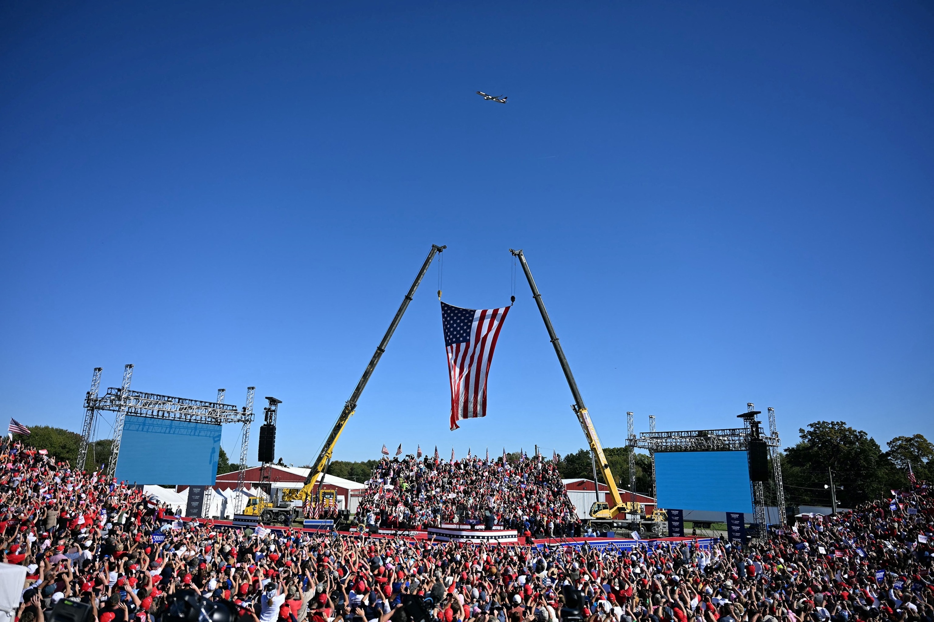 PHOTO: The plane of former President and Republican presidential candidate Donald Trump, known as Trump Force One, flies over the crowd ahead of a campaign rally in Butler, Pennsylvania, on Oct. 5, 2024, 