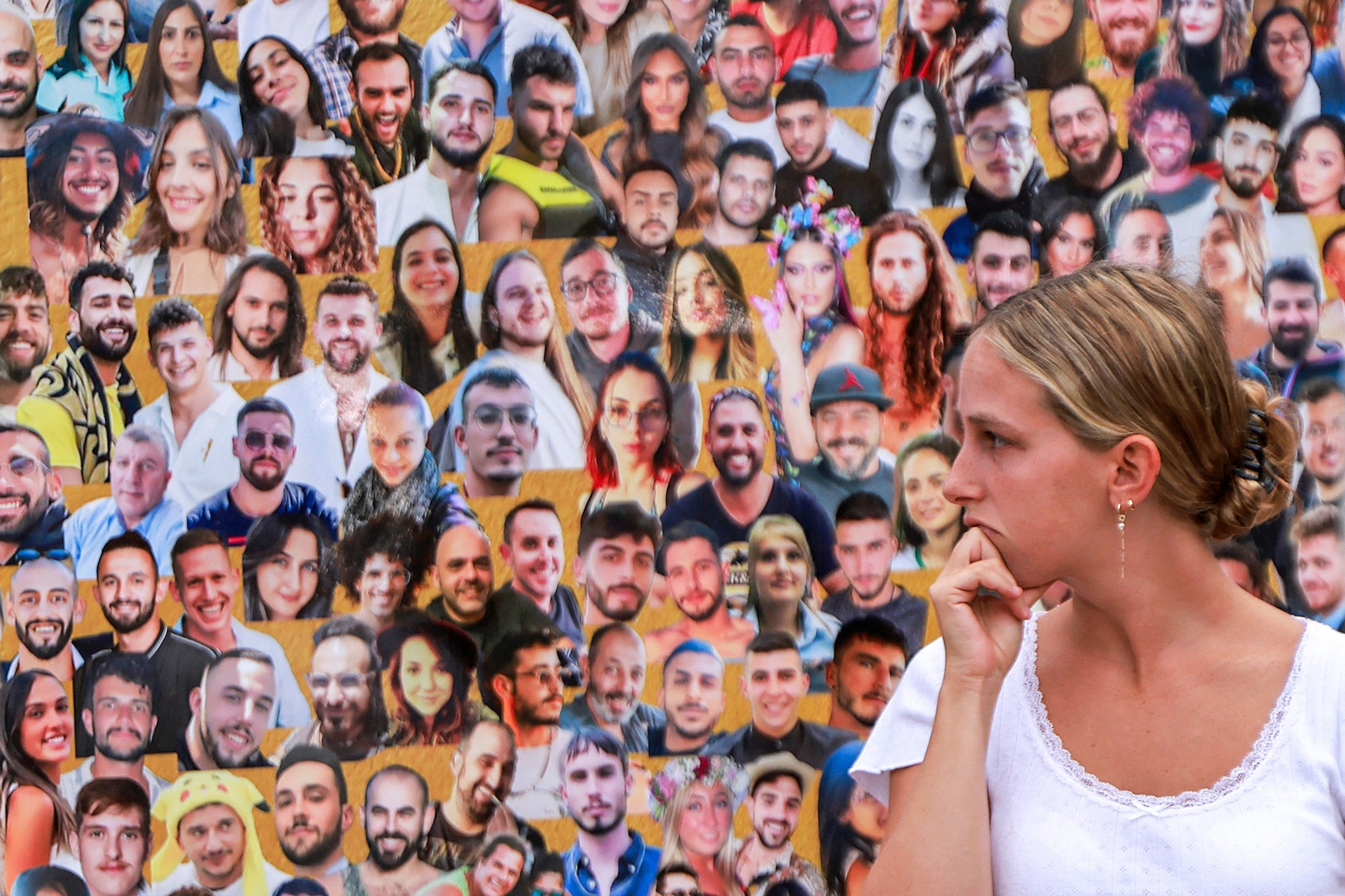 PHOTO: A woman views the images of the victims killed at or kidnapped from the Supernova music festival during the October 7 attacks by Palestinian militants, at the festival site near Kibbutz Reim in southern Israel, on Oct. 6, 2024. 