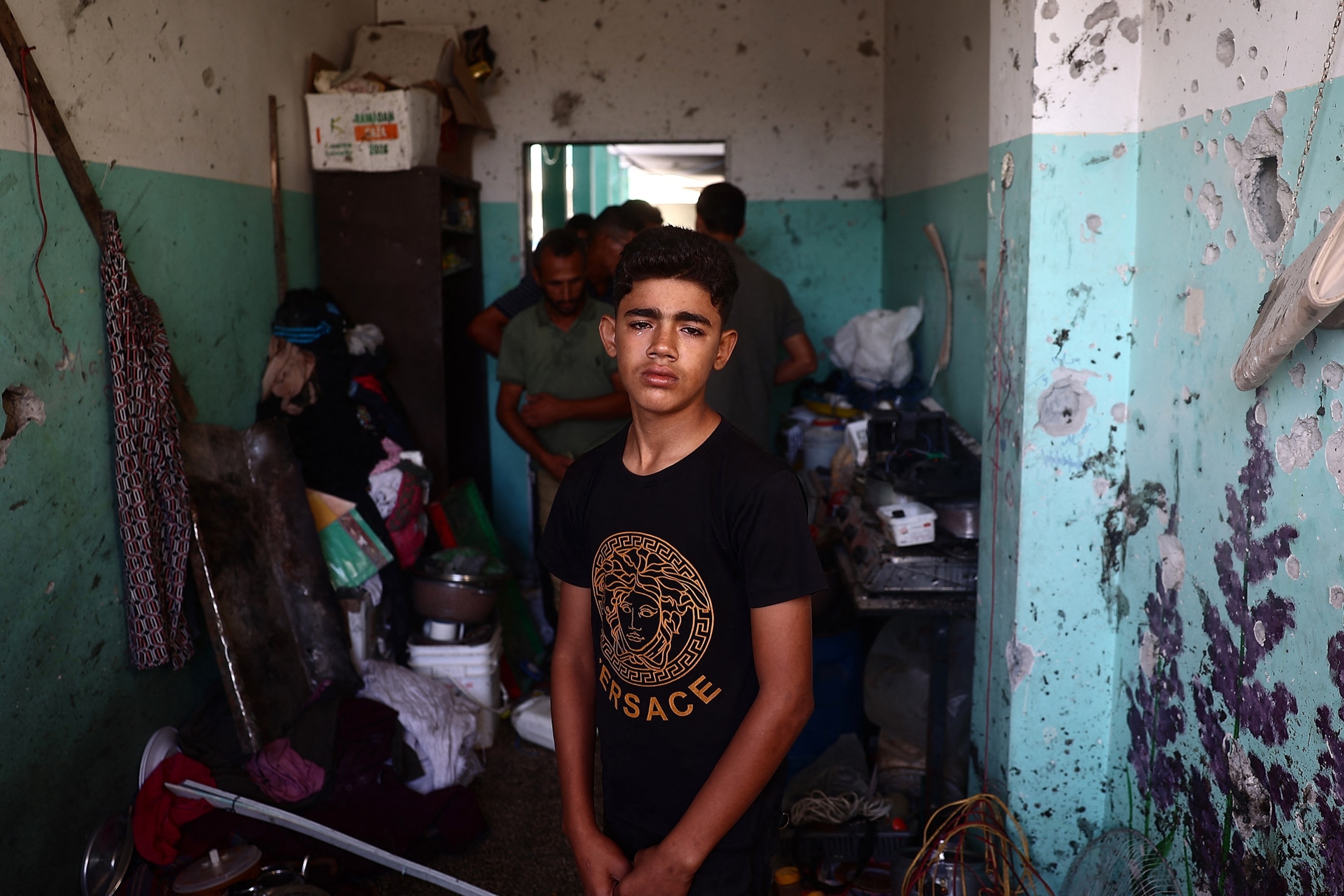 PHOTO: A Palestinian boy weeps as he checks the damage at a room at a school sheltering displaced people after an Israeli air strike hit the site, in Nuseirat in the central Gaza Strip on September 23, 2024.